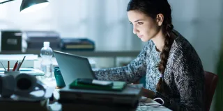 A girl studying on a laptop 