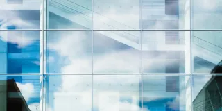 a glass wall with a staircase behind it