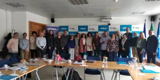 A group of people standing along the wall