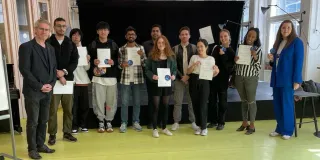 Group of students with diplomas