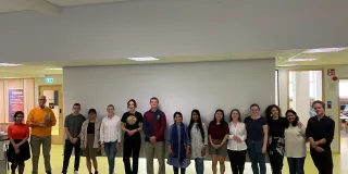 Group of students standing in front of the classroom