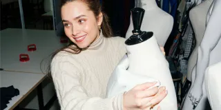 Nainen pukemassa mallinukkea