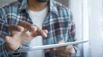 Hands on iPad tablet.