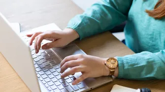 At office woman working with laptop.