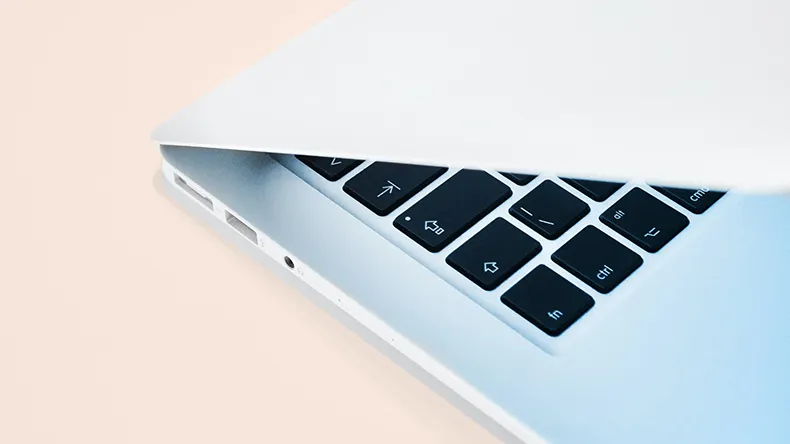 Laptop on a light beige background.