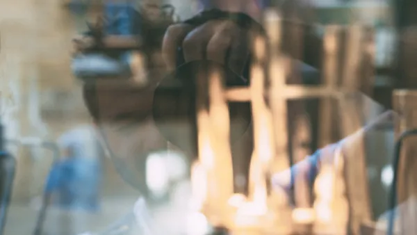 A reflection of a man taking a picture 