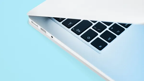 Laptop on a light blue background.