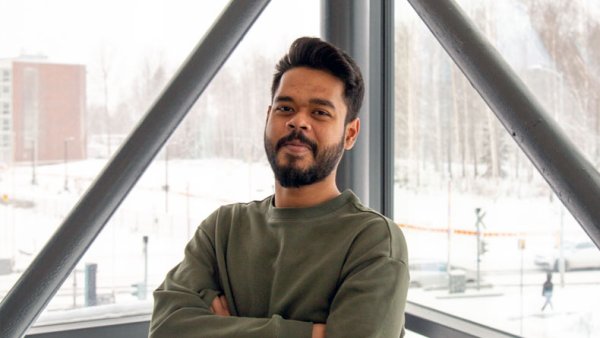 Yan Chowdhur - an international business student standing in front of window at the Lahti Campus