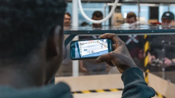 A man holding a phone and filming