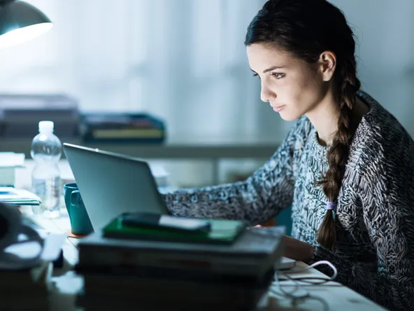 A girl studying on a laptop 