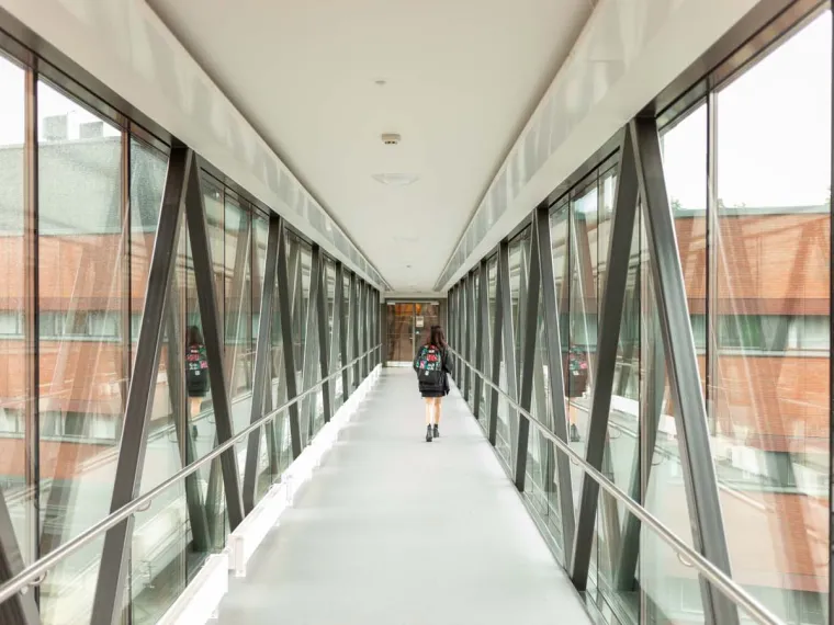 A student walking down the hallway on Lappeenranta Campus