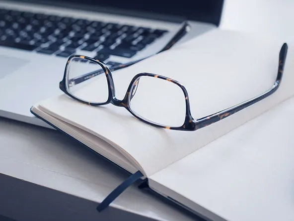 Laptop keyboard, notes and glasses 