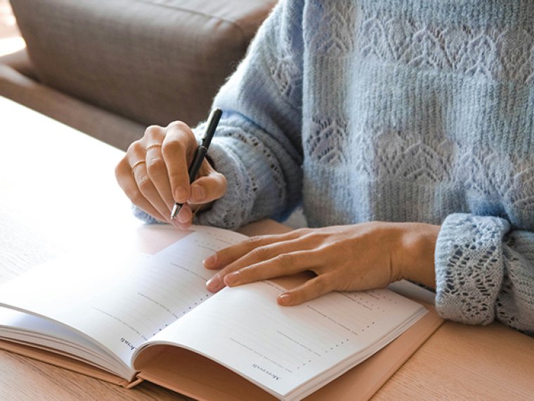Notebook writing in a living room.