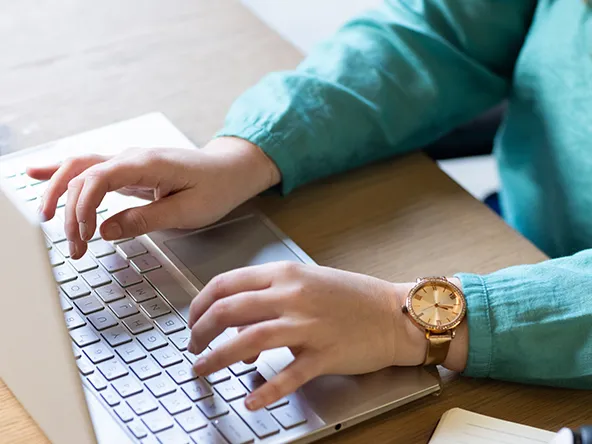 At office woman working with laptop.