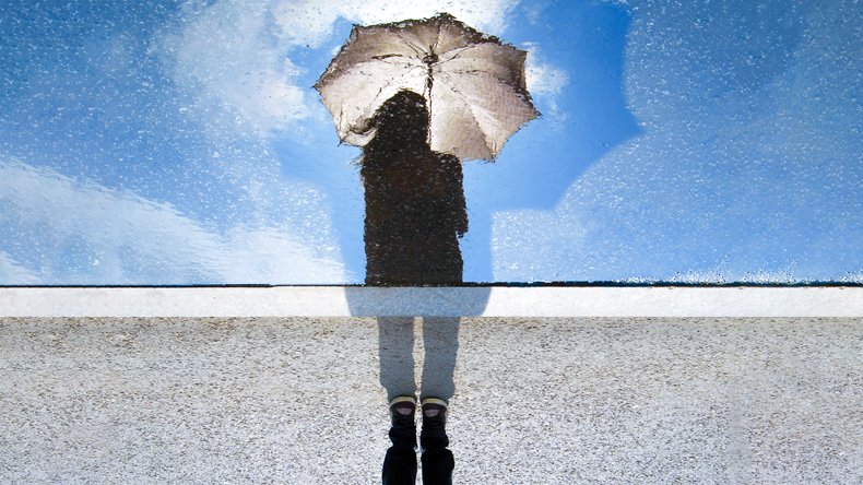 A girl with umbrella reflected