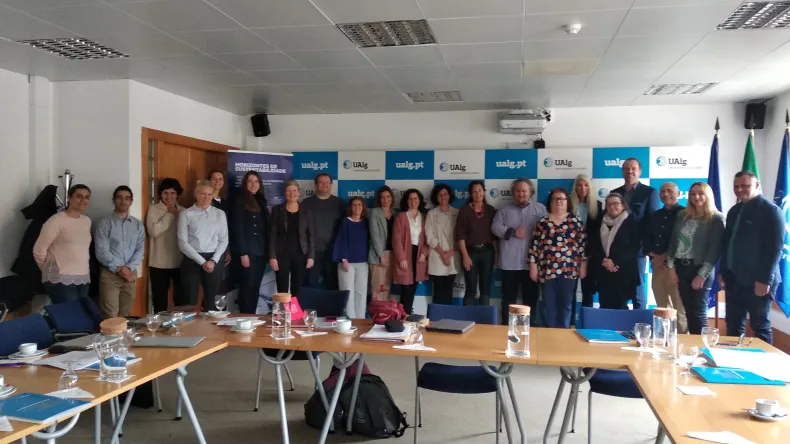 A group of people standing along the wall