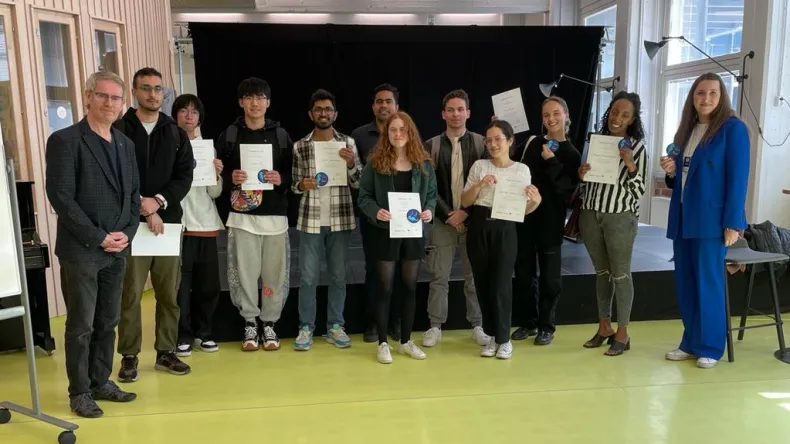 Group of students with diplomas