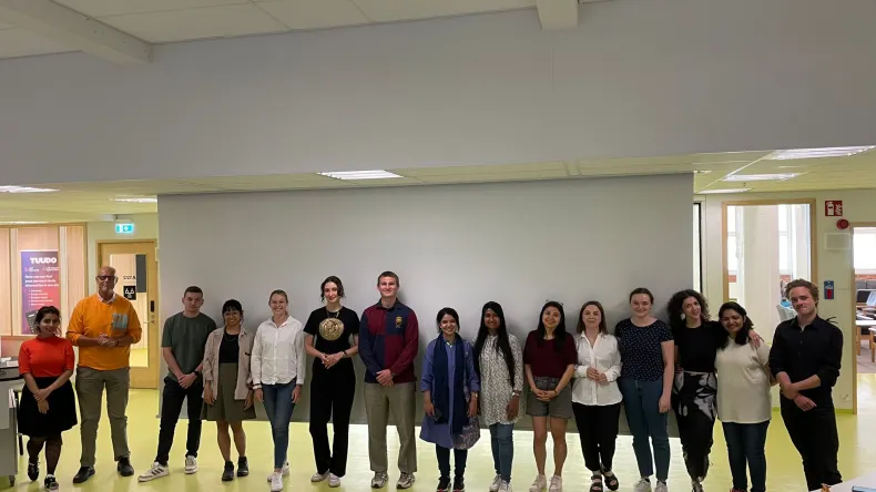Group of students standing in front of the classroom
